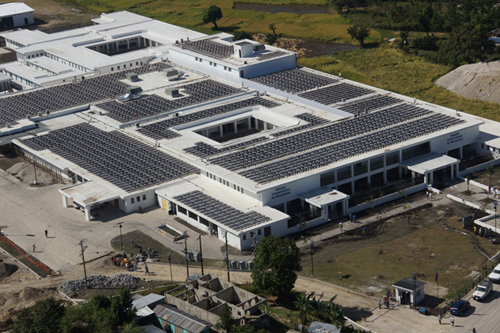 Partners In Health is no stranger to solar energy. In 2007, we collaborated with the Solar Electric Light Fund (SELF): to install small-scalesolar-energy systems at five clinics in rural Rwanda. Soon after, similar programs cropped up at PIH sites in Malawi, Lesotho, and Haiti. But scaling this technology to deliver reliable power for a 300-bed hospital demanded elegant design and extensive collaboration. “The challenge was in the design and engineering, and getting the solar power produced to mesh with the often unstable grids and the backup generators,” said Jim Ansara, University Hospital’s director of design and construction. “At each step of the way, we were attempting things that had never before been done in Haiti.” Solon, a German company, supplied the solar panels while Massachusetts-based Solectria Renewables manufactured the inverters, devices that convert the electricity and send it to the grid. To get the system up and running, engineers from Sullivan &amp; McLaughlin Companies traveled to Haiti and trained six local electricians how to install and maintain the system. Two of the Haitian electricians are continuing to work at the hospital full-time now that it is open. Overall, it's estimated the hospital will create more than 800 new jobs for Haitians.  Photograph courtesy of Partners In Health